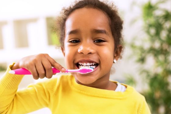 cute little girl brushing her teeth with Arm and hammer kids toothpaste formula