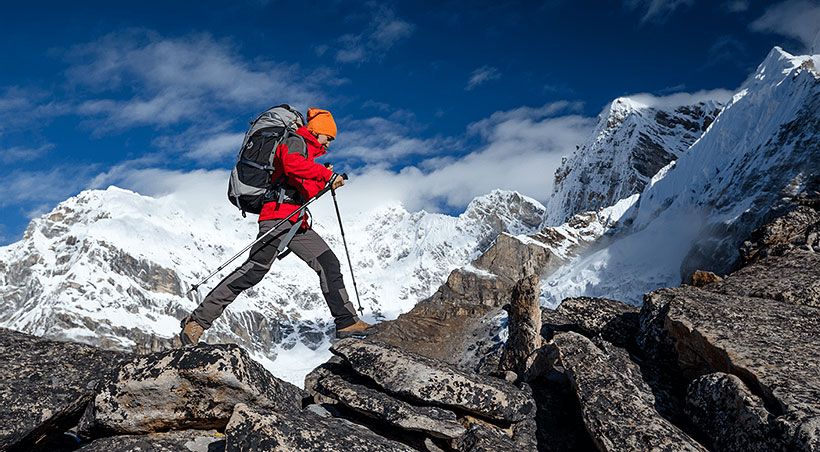 white man hiking through mountains